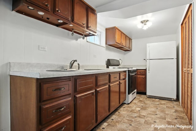 67 Wells St, Fox Lake, IL 60020 - kitchen featuring white appliances, light countertops, and stone finish floors
