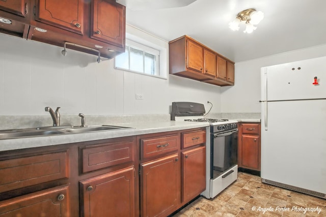 67 Wells St, Fox Lake, IL 60020 - kitchen featuring freestanding refrigerator, range with gas stovetop, and light countertops