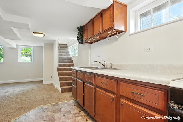 67 Wells St, Fox Lake, IL 60020 - kitchen featuring light countertops, brown cabinets, light carpet, and open floor plan