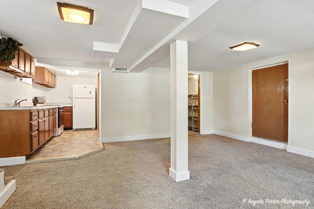 67 Wells St, Fox Lake, IL 60020 - kitchen featuring freestanding refrigerator, light colored carpet, brown cabinets, light countertops, and open floor plan