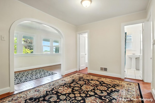 67 Wells St, Fox Lake, IL 60020 - foyer featuring arched walkways, wood finished floors, and ornamental molding