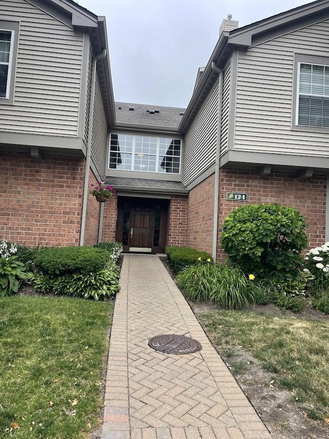 124 White Oak Ct Unit 2, Schaumburg, IL 60195 - doorway to property featuring brick siding and a chimney