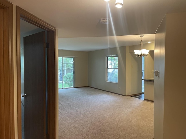 124 White Oak Ct Unit 2, Schaumburg, IL 60195 - spare room featuring carpet, a chandelier, and a smoke detector