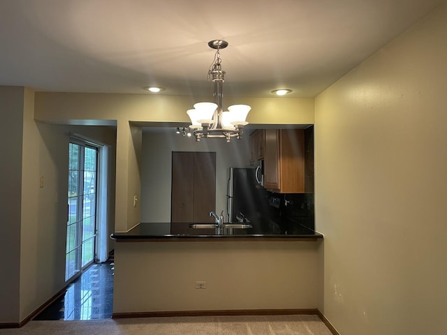 124 White Oak Ct Unit 2, Schaumburg, IL 60195 - kitchen featuring dark countertops, a peninsula, a chandelier, and hanging light fixtures