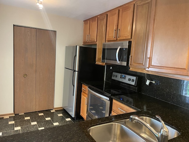 124 White Oak Ct Unit 2, Schaumburg, IL 60195 - kitchen featuring appliances with stainless steel finishes, tasteful backsplash, dark floors, dark stone counters, and brown cabinetry