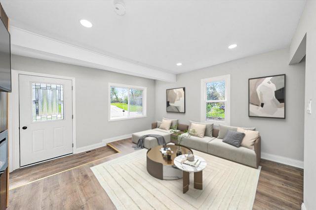 1326 N Poplar Ave, Round Lake Beach, IL 60073 - living room featuring healthy amount of natural light, wood finished floors, and recessed lighting