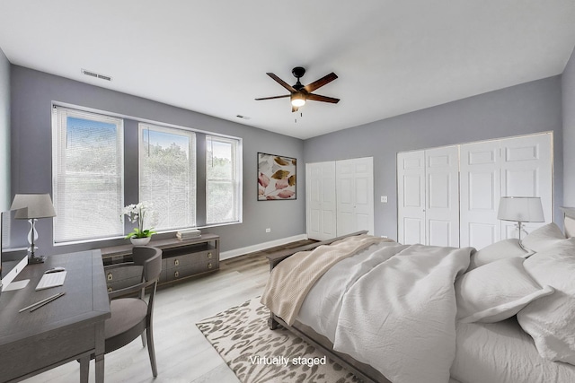 6415 S Kimbark Ave Unit 3, Chicago, IL 60637 - bedroom featuring two closets, light wood finished floors, a ceiling fan, and a desk