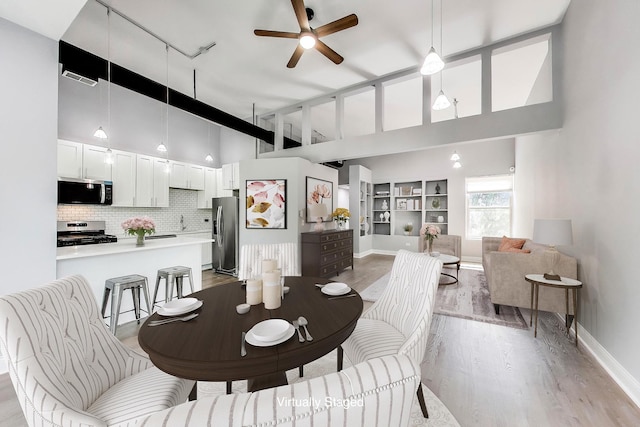6415 S Kimbark Ave Unit 3, Chicago, IL 60637 - dining area with light wood-style floors, high vaulted ceiling, a ceiling fan, rail lighting, and built in shelves
