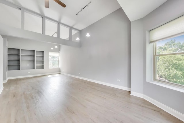6415 S Kimbark Ave Unit 3, Chicago, IL 60637 - empty room featuring rail lighting, healthy amount of natural light, ceiling fan, built in shelves, and high vaulted ceiling