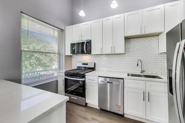 6415 S Kimbark Ave Unit 3, Chicago, IL 60637 - kitchen featuring stainless steel appliances, light countertops, backsplash, white cabinets, and light wood-type flooring