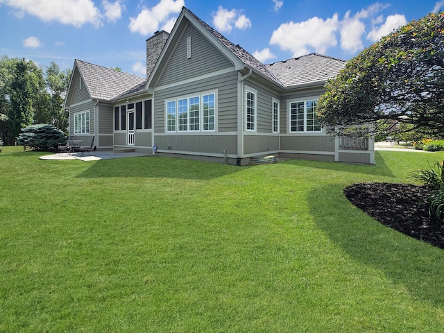 807 Wedgewood Ct, Lindenhurst, IL 60046 - back of house with a chimney, a patio, and a lawn