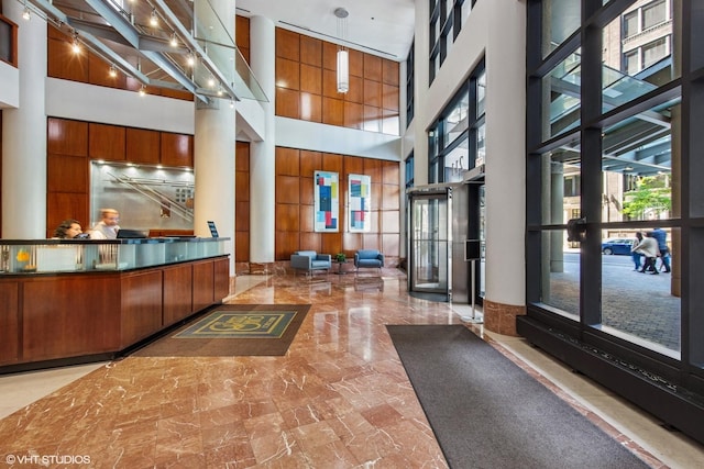 211 E Ohio St Unit 1825, Chicago, IL 60611 - welcome area featuring a towering ceiling, ornate columns, french doors, and wooden walls