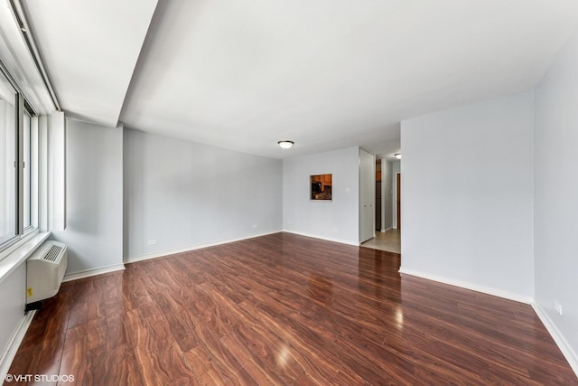 211 E Ohio St Unit 1825, Chicago, IL 60611 - empty room with a wall mounted AC and wood finished floors