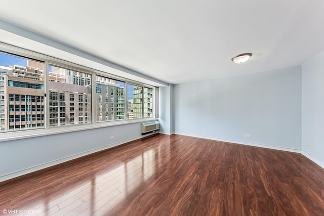 211 E Ohio St Unit 1825, Chicago, IL 60611 - spare room with wood finished floors, a wall mounted air conditioner, and a view of city