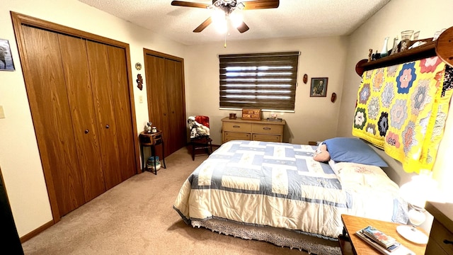 500 Jenkran Way Unit 2, Morrison, IL 61270 - bedroom featuring light colored carpet, multiple closets, a textured ceiling, and a ceiling fan
