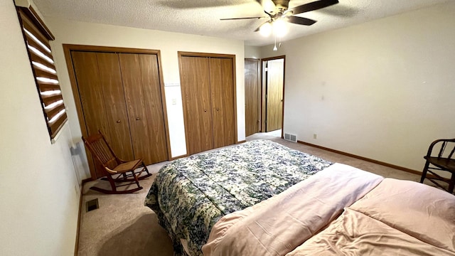 500 Jenkran Way Unit 2, Morrison, IL 61270 - bedroom with carpet floors, two closets, a textured ceiling, and ceiling fan