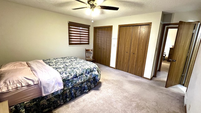 500 Jenkran Way Unit 2, Morrison, IL 61270 - bedroom with multiple closets, carpet floors, a textured ceiling, and ceiling fan