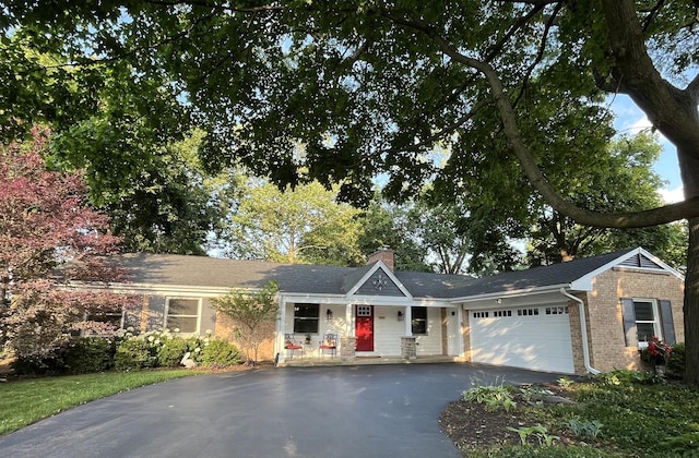 441 Highland Ave, Crystal Lake, IL 60014 - view of front of home with asphalt driveway, a chimney, an attached garage, and brick siding