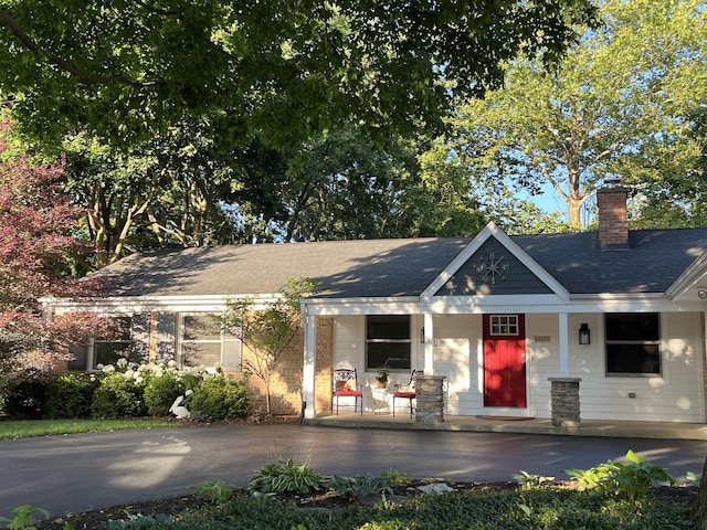 441 Highland Ave, Crystal Lake, IL 60014 - view of front of house featuring a porch, a chimney, roof with shingles, and driveway