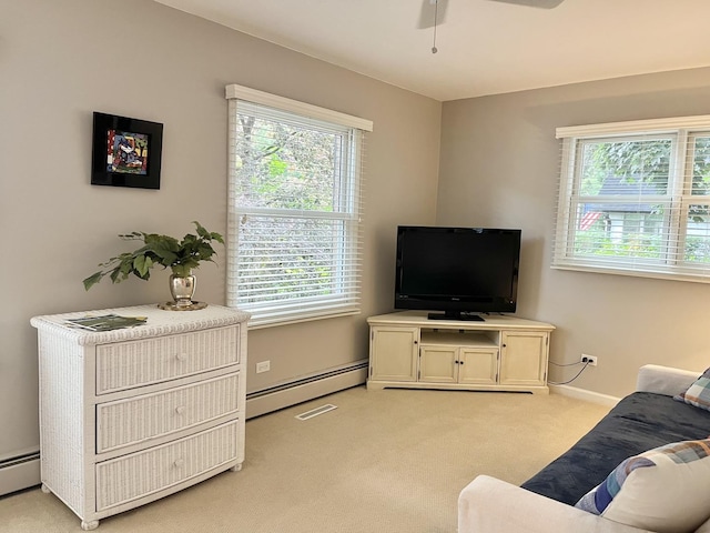 441 Highland Ave, Crystal Lake, IL 60014 - living room with a baseboard radiator, light carpet, and a ceiling fan