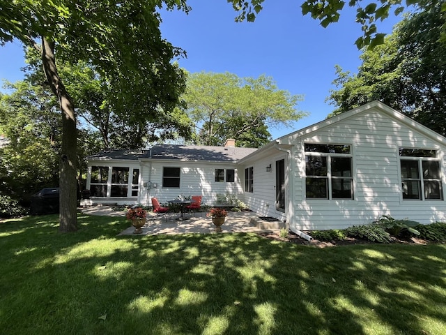 441 Highland Ave, Crystal Lake, IL 60014 - back of property featuring a patio, a lawn, and a chimney