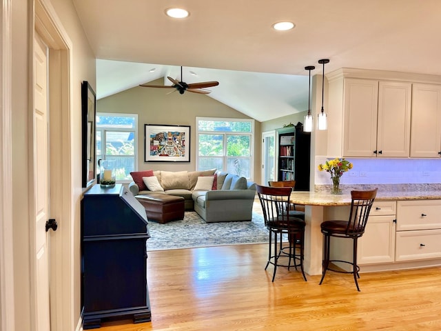 441 Highland Ave, Crystal Lake, IL 60014 - kitchen featuring plenty of natural light, ceiling fan, open floor plan, lofted ceiling, and white cabinets
