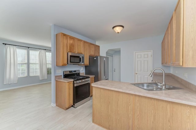 24341 Leski Ln, Plainfield, IL 60585 - kitchen featuring appliances with stainless steel finishes, a peninsula, light wood finished floors, and light countertops