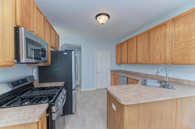24341 Leski Ln, Plainfield, IL 60585 - kitchen featuring stainless steel appliances, light countertops, light wood-type flooring, and a peninsula