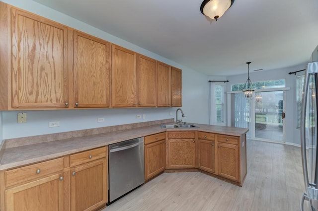 24341 Leski Ln, Plainfield, IL 60585 - kitchen featuring stainless steel appliances, a peninsula, light wood-style flooring, and hanging light fixtures