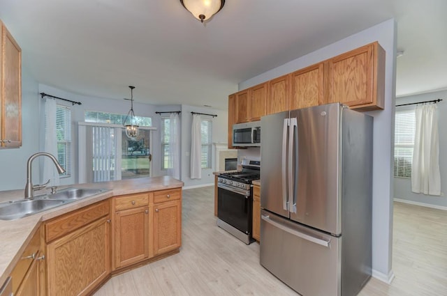 24341 Leski Ln, Plainfield, IL 60585 - kitchen featuring stainless steel appliances, light wood-style flooring, light countertops, and a peninsula