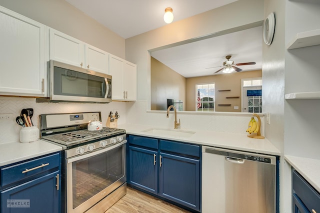 2326 Woodhill Ct, Plainfield, IL 60586 - kitchen featuring stainless steel appliances, blue cabinetry, and white cabinets