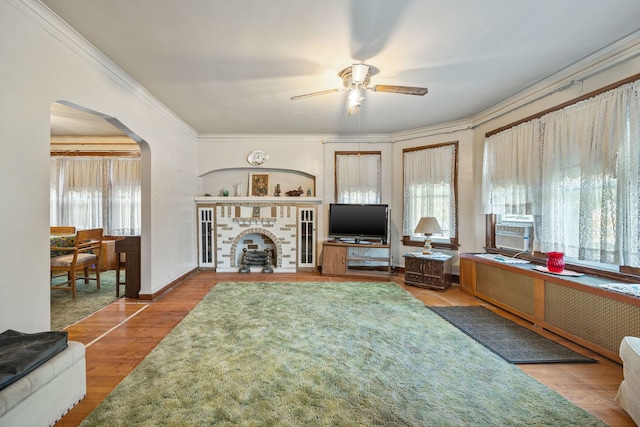 2955 N Lotus Ave, Chicago, IL 60641 - living room with arched walkways, ceiling fan, wood finished floors, crown molding, and cooling unit