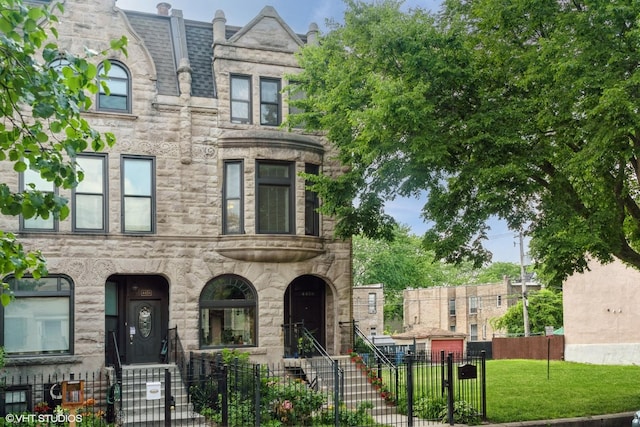 4456 S Berkeley Ave, Chicago, IL 60653 - view of property featuring a fenced front yard, a gate, and stone siding