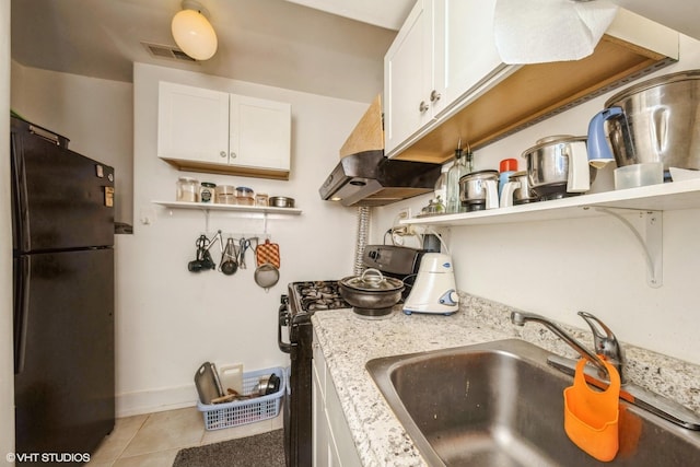 4456 S Berkeley Ave, Chicago, IL 60653 - kitchen with black appliances, open shelves, under cabinet range hood, white cabinets, and light tile patterned floors