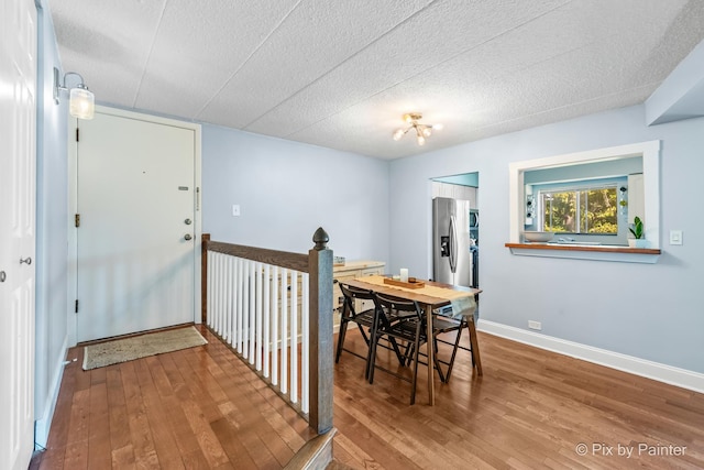 61 W Pier Dr Unit 201, Westmont, IL 60559 - dining area featuring wood-type flooring and a textured ceiling