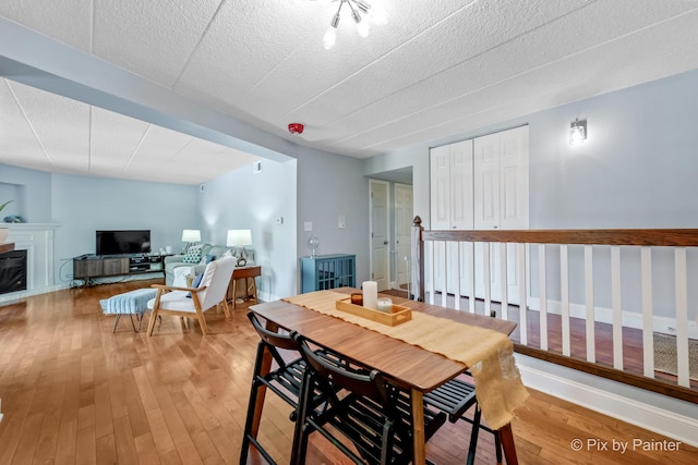 61 W Pier Dr Unit 201, Westmont, IL 60559 - dining room featuring light wood finished floors and a glass covered fireplace