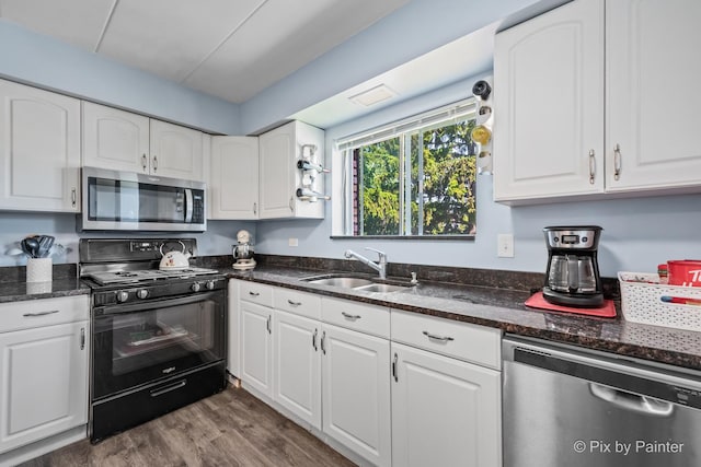 61 W Pier Dr Unit 201, Westmont, IL 60559 - kitchen with appliances with stainless steel finishes, white cabinetry, dark stone countertops, and dark wood-style floors