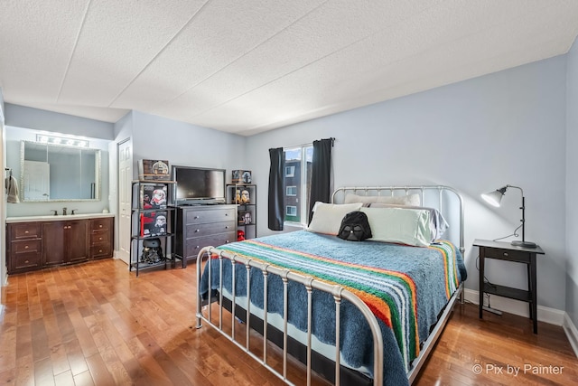 61 W Pier Dr Unit 201, Westmont, IL 60559 - bedroom featuring light wood finished floors and a textured ceiling