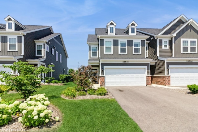 24518 W Alexis Ln, Plainfield, IL 60585 - craftsman-style house featuring an attached garage, asphalt driveway, brick siding, and a front yard
