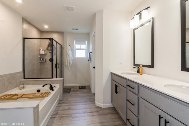 24518 W Alexis Ln, Plainfield, IL 60585 - bathroom with a stall shower, double vanity, a bath, wood finished floors, and recessed lighting