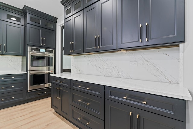 25216 S Channault Ave, Monee, IL 60449 - kitchen featuring double oven, light wood-style floors, glass insert cabinets, and light stone countertops