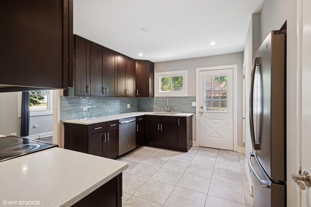 2543 Crawford Ave, Evanston, IL 60201 - kitchen featuring stainless steel appliances, backsplash, dark brown cabinetry, and recessed lighting