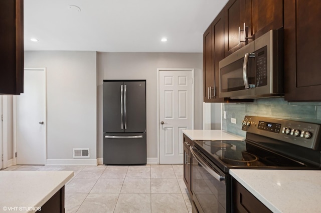 2543 Crawford Ave, Evanston, IL 60201 - kitchen featuring stainless steel appliances, dark brown cabinets, decorative backsplash, light tile patterned flooring, and recessed lighting