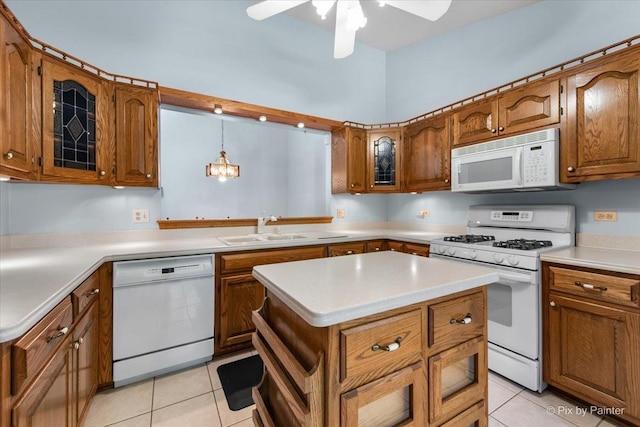 81 Castle Rock Ln, Bloomingdale, IL 60108 - kitchen featuring white appliances, brown cabinetry, light tile patterned floors, and a ceiling fan