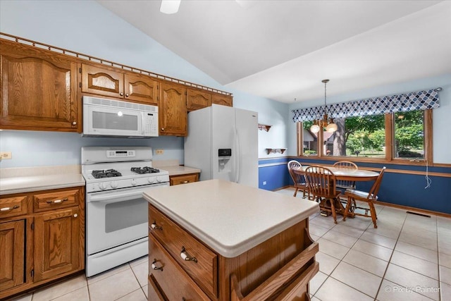 81 Castle Rock Ln, Bloomingdale, IL 60108 - kitchen with white appliances, brown cabinets, light tile patterned floors, and lofted ceiling
