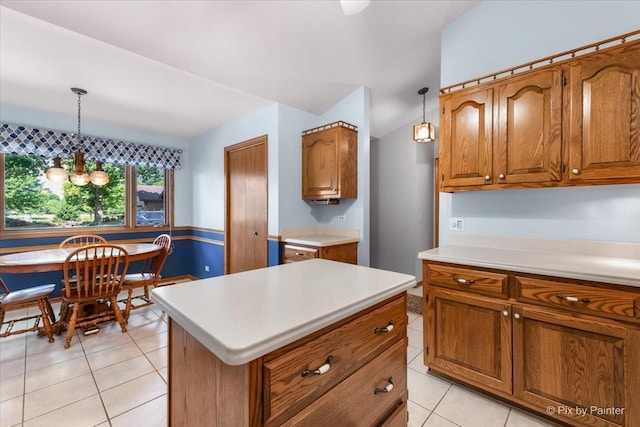 81 Castle Rock Ln, Bloomingdale, IL 60108 - kitchen with brown cabinets, light tile patterned floors, light countertops, a chandelier, and pendant lighting