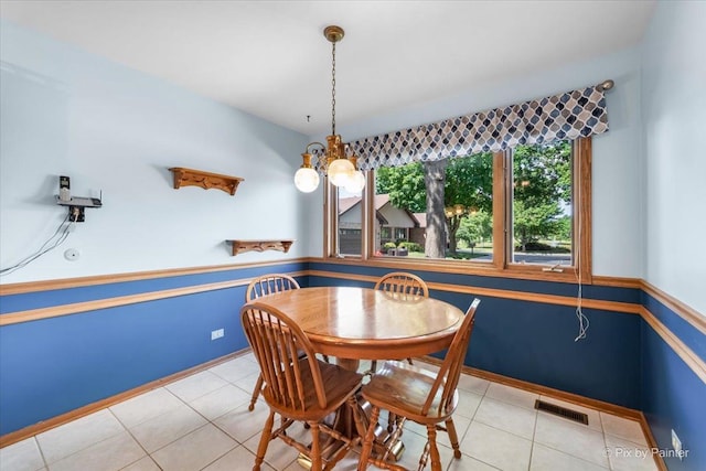 81 Castle Rock Ln, Bloomingdale, IL 60108 - tiled dining space featuring a wainscoted wall and baseboards