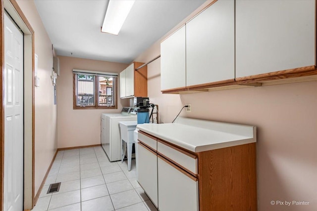 81 Castle Rock Ln, Bloomingdale, IL 60108 - washroom featuring cabinet space, washer and dryer, and light tile patterned flooring
