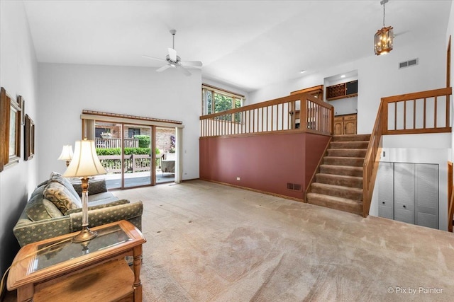 81 Castle Rock Ln, Bloomingdale, IL 60108 - unfurnished living room featuring ceiling fan, high vaulted ceiling, stairway, and carpet