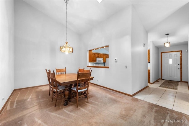 81 Castle Rock Ln, Bloomingdale, IL 60108 - dining area featuring high vaulted ceiling, light carpet, and a chandelier